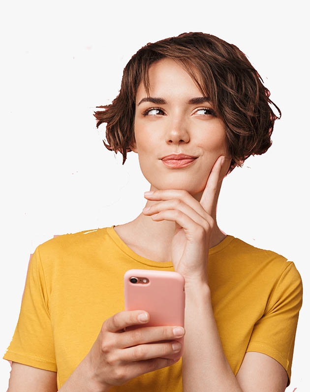 Thinking dreaming young beautiful woman posing isolated over pink wall background using mobile phone.